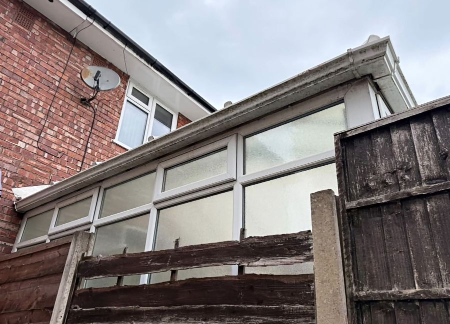 Gutter, soffits and fascias covered in green grime before cleaning